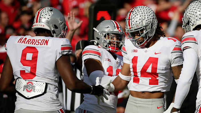 Ohio State players celebrate a sack of Nebraska